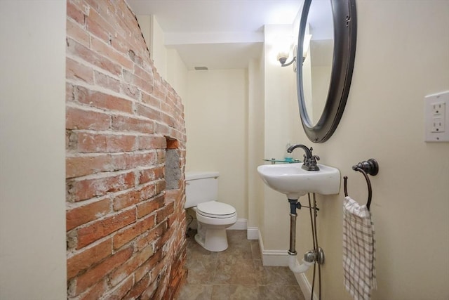 137 High St, Danvers, MA 01923 - bathroom with brick wall and tile patterned flooring