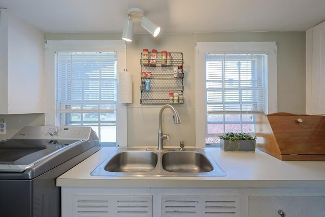 137 High St, Danvers, MA 01923 - kitchen featuring washer / clothes dryer, white cabinetry, and light countertops