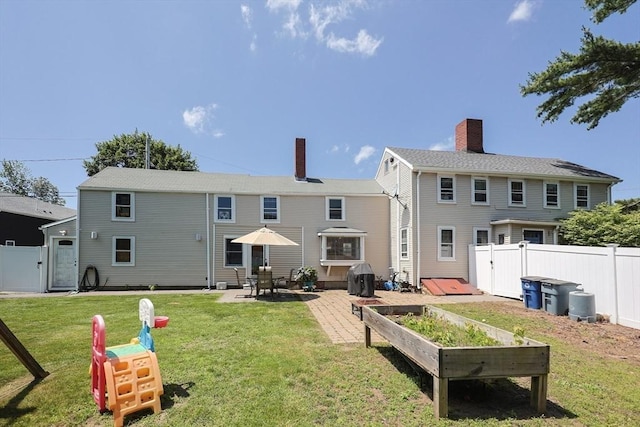 137 High St, Danvers, MA 01923 - rear view of property with a patio area, a chimney, and a gate
