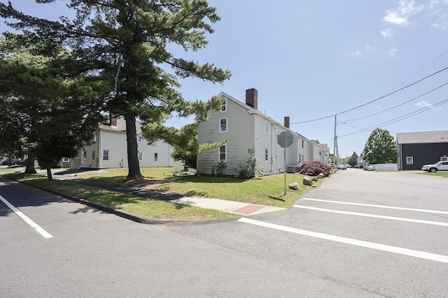 137 High St, Danvers, MA 01923 - view of property exterior with a lawn and a chimney