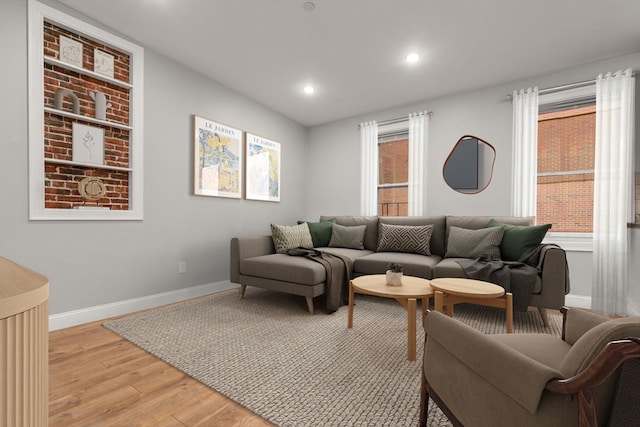 living room featuring light wood-type flooring and a healthy amount of sunlight