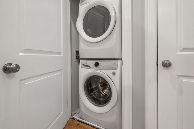 laundry area with stacked washing maching and dryer