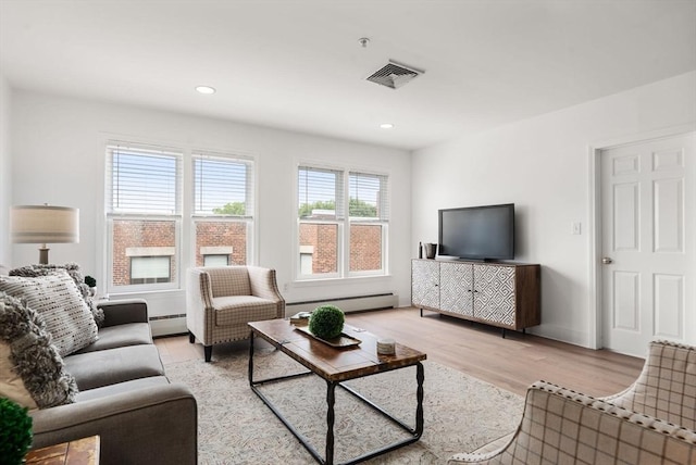 1 Davenport St Unit 11, Cambridge, MA 02140 - living area with baseboard heating, a baseboard radiator, light wood-style floors, recessed lighting, and baseboards