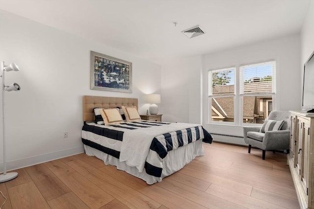 1 Davenport St Unit 11, Cambridge, MA 02140 - bedroom featuring light wood finished floors, a baseboard heating unit, and baseboards
