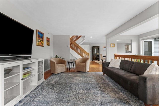 living room featuring stairway, recessed lighting, and wood finished floors