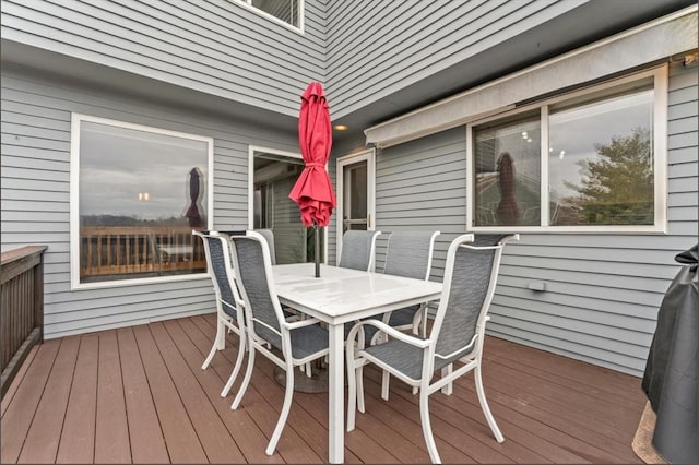 wooden terrace with outdoor dining space