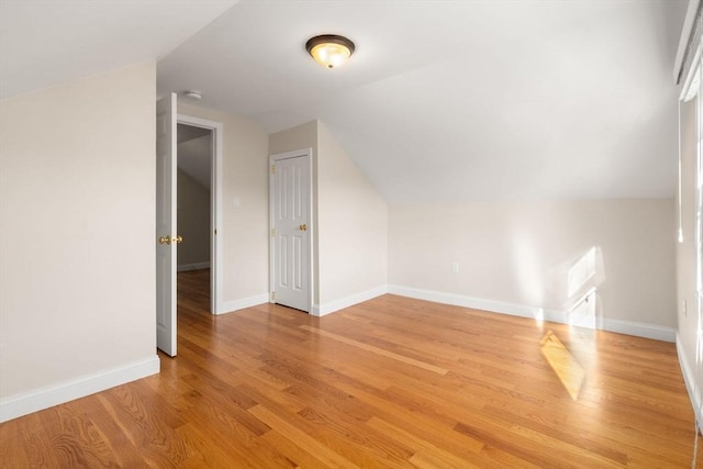 bonus room featuring light wood-type flooring and lofted ceiling