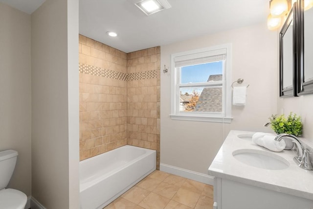 full bathroom with toilet, vanity, tiled shower / bath, and tile patterned flooring