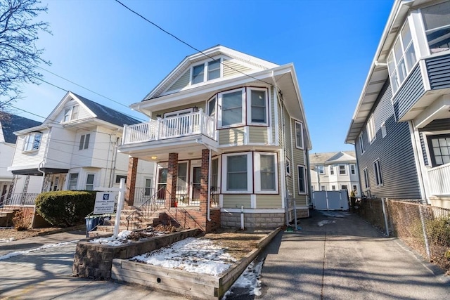 view of front of house with a balcony and covered porch