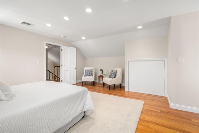 bedroom with lofted ceiling and hardwood / wood-style floors