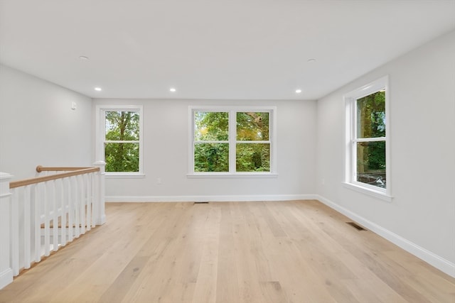 unfurnished room featuring light hardwood / wood-style floors