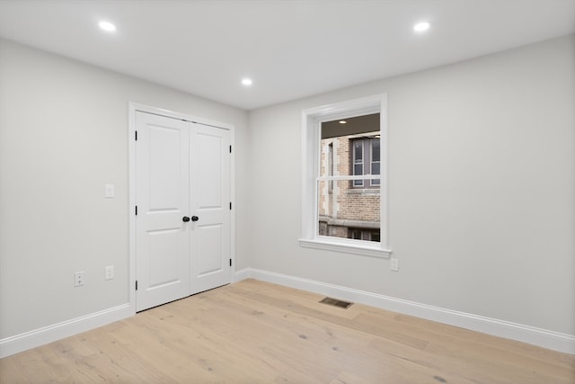 empty room with light hardwood / wood-style floors