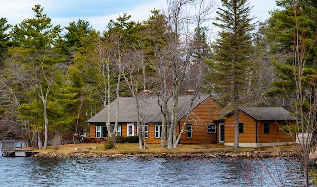 view of front of home featuring a water view and faux log siding
