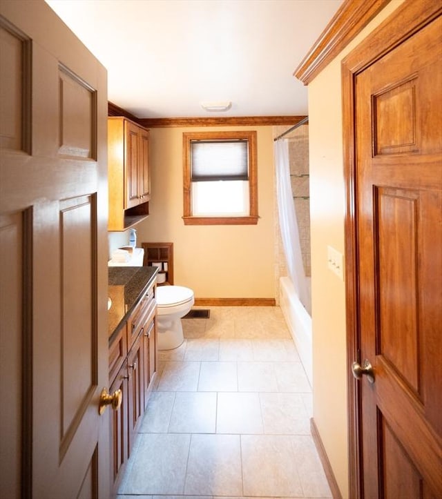 bathroom featuring visible vents, baseboards, toilet, vanity, and tile patterned floors