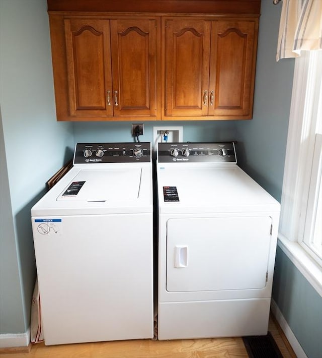 laundry area with baseboards, cabinet space, and washer and clothes dryer