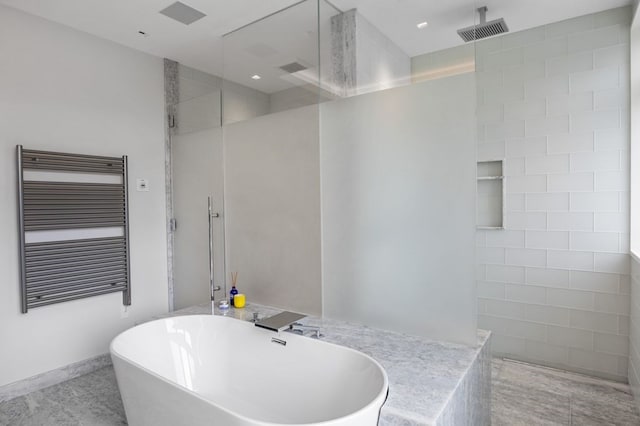 bathroom featuring shower with separate bathtub, radiator, and tile flooring