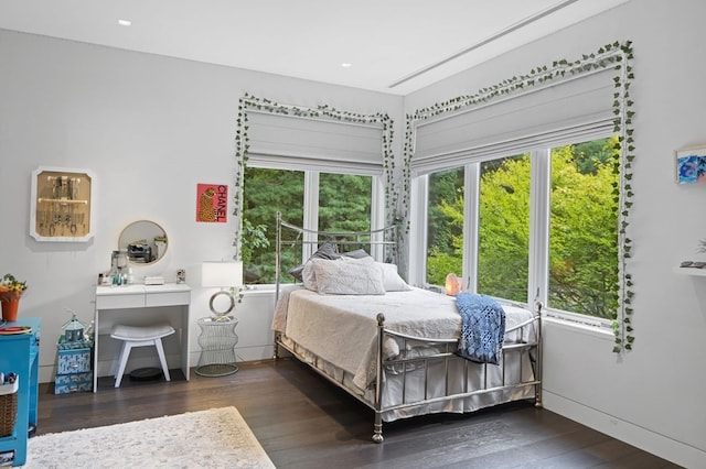 bedroom with dark hardwood / wood-style floors