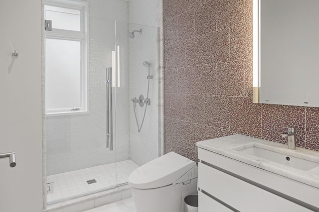 bathroom featuring walk in shower, large vanity, toilet, and tile walls