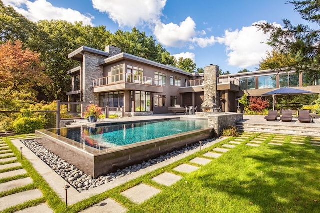 view of pool with a patio and a yard