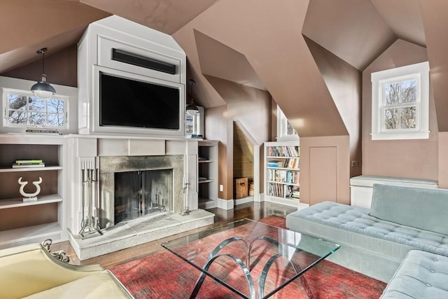 living room featuring vaulted ceiling, a high end fireplace, and hardwood / wood-style floors