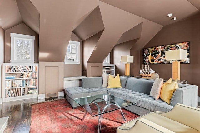 living room featuring lofted ceiling and dark hardwood / wood-style flooring