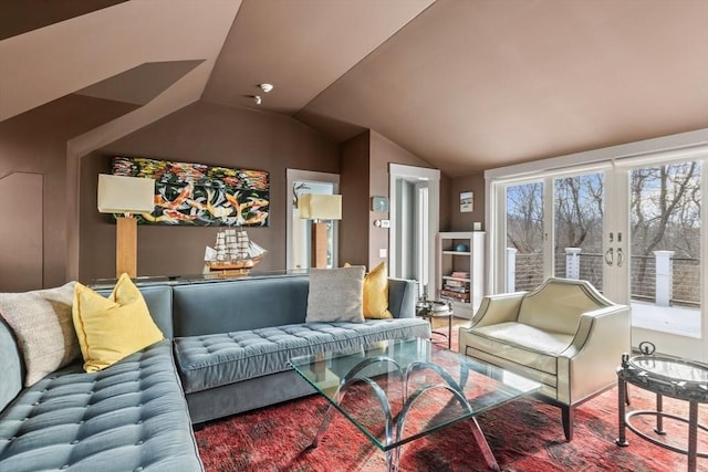 living room with vaulted ceiling and french doors