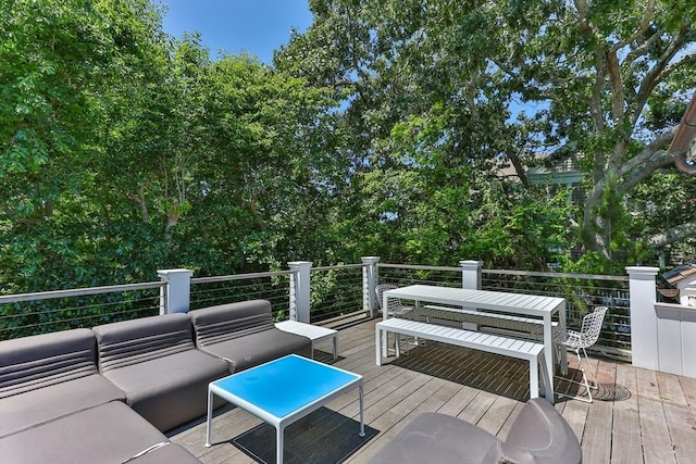 wooden terrace with an outdoor hangout area