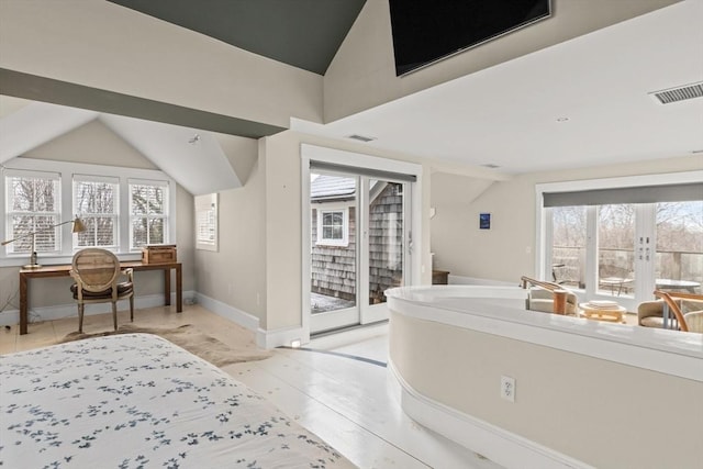 bedroom featuring french doors, vaulted ceiling, multiple windows, and access to outside