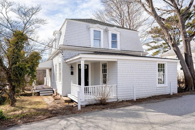 view of front of home with a porch and a shingled roof