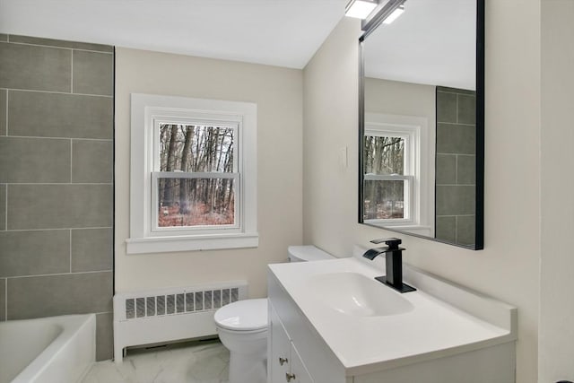 bathroom with vanity, radiator heating unit, and toilet