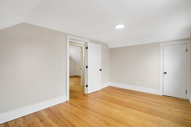 bonus room with vaulted ceiling and light hardwood / wood-style floors