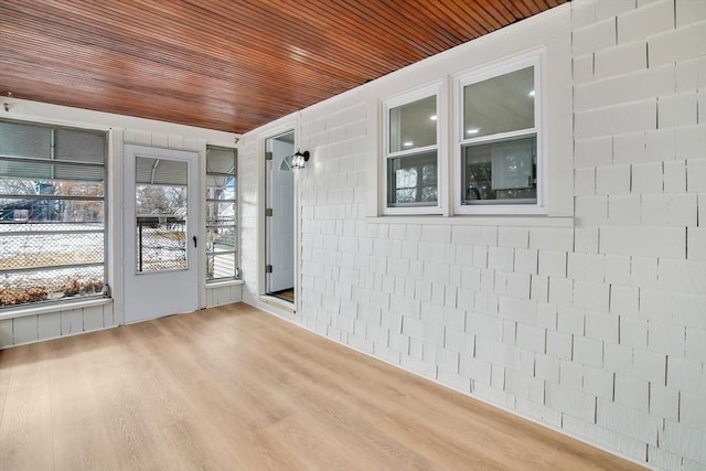 unfurnished sunroom with wooden ceiling