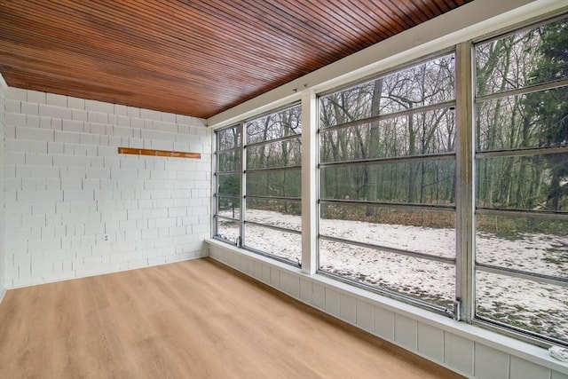 unfurnished sunroom with wooden ceiling