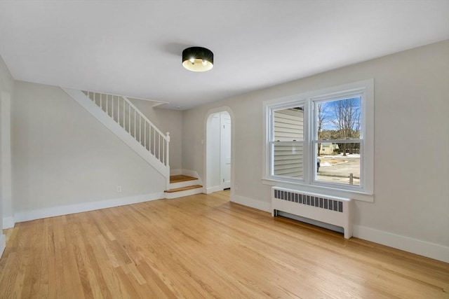 foyer featuring radiator heating unit and light wood-type flooring