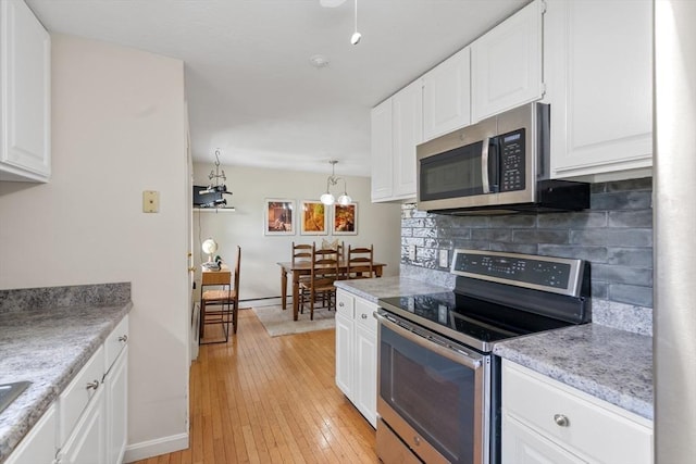 42 Sycamore Dr Unit 42, Leominster, MA 01453 - kitchen featuring appliances with stainless steel finishes, white cabinetry, light countertops, and light wood-style flooring