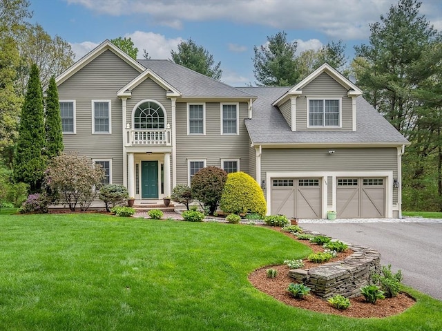 136 Howard St, Northborough, MA 01532 - view of front of house featuring a front lawn, a garage, a shingled roof, and driveway