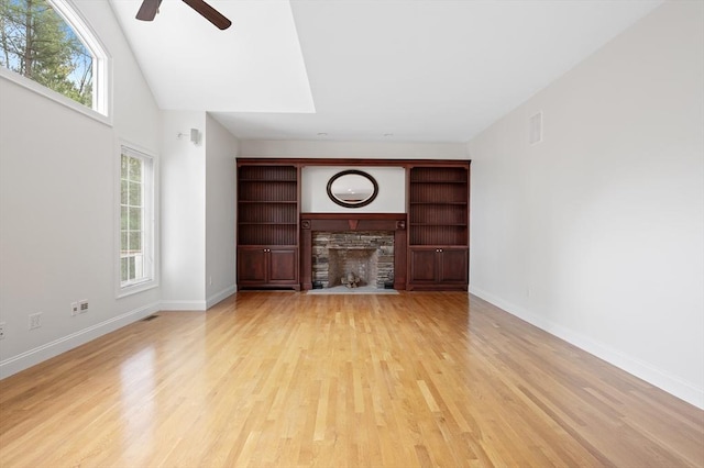 136 Howard St, Northborough, MA 01532 - unfurnished living room with ceiling fan, a fireplace, healthy amount of natural light, and light wood-style floors