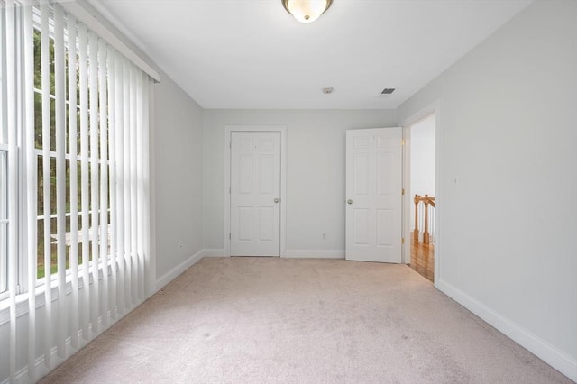 136 Howard St, Northborough, MA 01532 - unfurnished bedroom featuring multiple windows, carpet floors, and baseboards