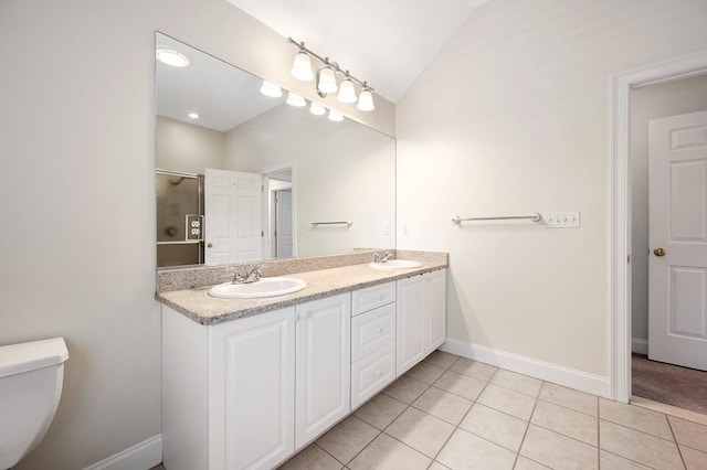 136 Howard St, Northborough, MA 01532 - full bath with tile patterned floors, baseboards, vaulted ceiling, toilet, and double vanity
