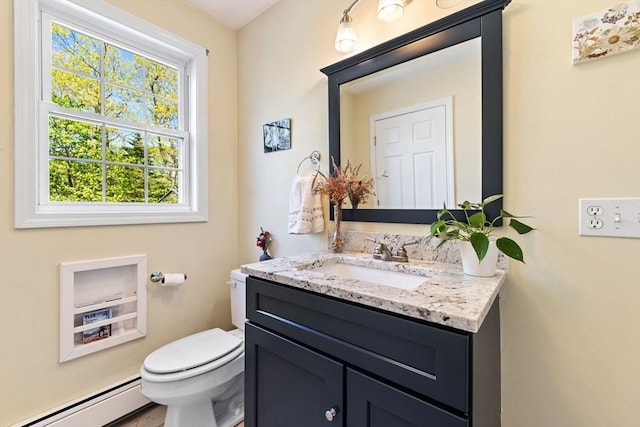 bathroom featuring vanity, baseboard heating, and toilet