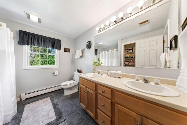 bathroom with visible vents, a sink, baseboard heating, and toilet