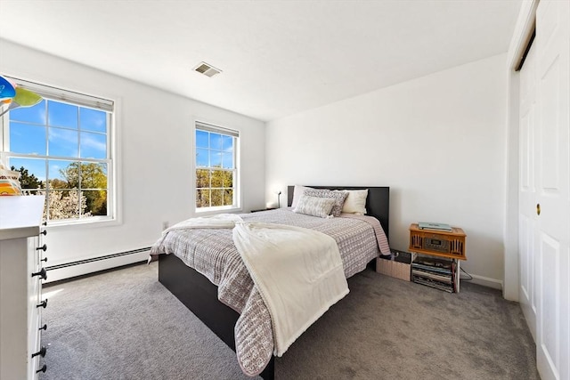 carpeted bedroom with a closet, baseboards, visible vents, and a baseboard radiator