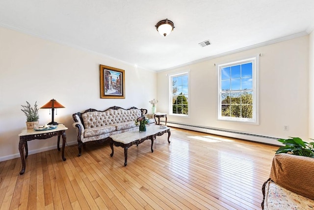 living area featuring visible vents, baseboard heating, baseboards, light wood finished floors, and ornamental molding
