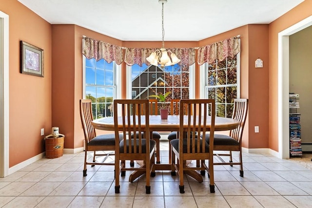 dining area featuring light tile patterned flooring, baseboards, and a notable chandelier
