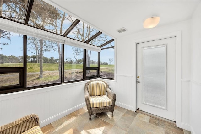 10 Lanyard Way Unit 7239, Mashpee, MA 02649 - sunroom / solarium featuring baseboards, wainscoting, and stone finish flooring