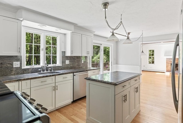 92 Clinton St, Hopkinton, MA 01748 - kitchen with dishwasher, range, light wood finished floors, and decorative backsplash