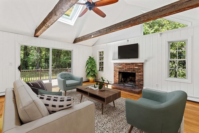 92 Clinton St, Hopkinton, MA 01748 - living area with wood finished floors, ceiling fan, a skylight, and a brick fireplace
