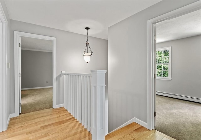 92 Clinton St, Hopkinton, MA 01748 - hallway featuring an upstairs landing, baseboard heating, light wood finished floors, and light carpet