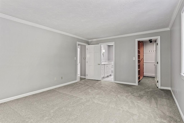 92 Clinton St, Hopkinton, MA 01748 - unfurnished bedroom with a spacious closet, carpet floors, ensuite bathroom, ornamental molding, and a closet