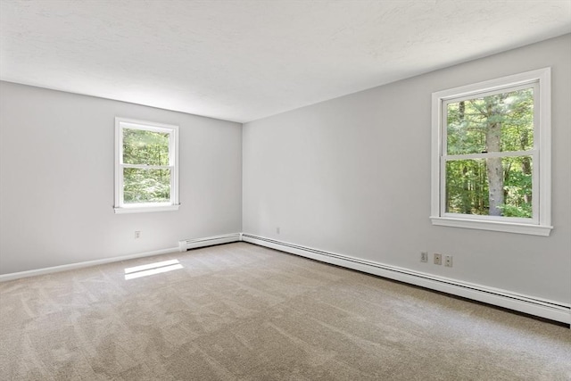 92 Clinton St, Hopkinton, MA 01748 - carpeted empty room featuring plenty of natural light and a baseboard heating unit